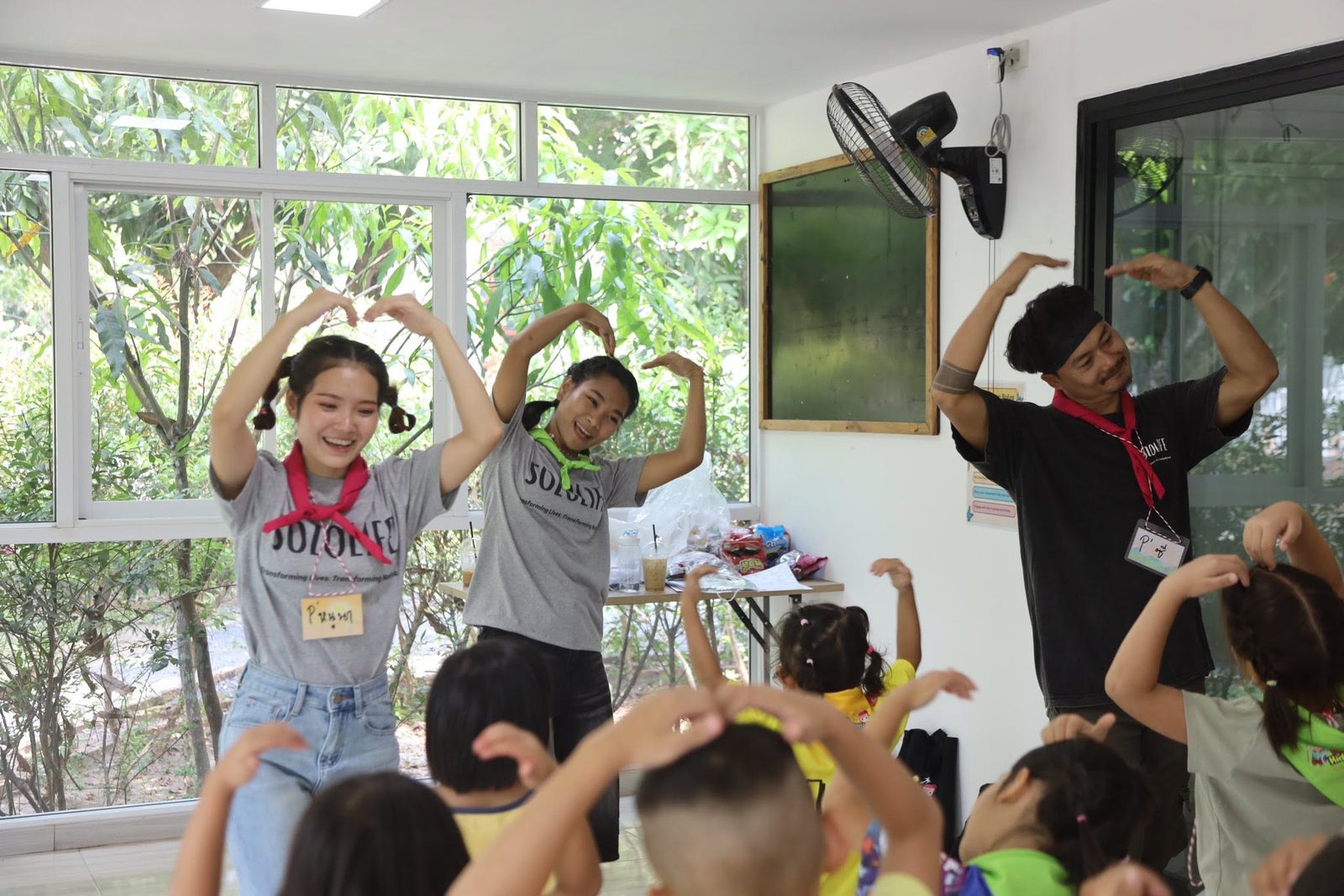Kids and teachers mid dance party in the classroom